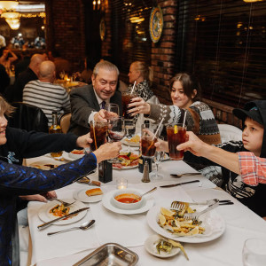 table of people enjoying drinks and food