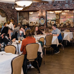 tables of people enjoying drinks and food