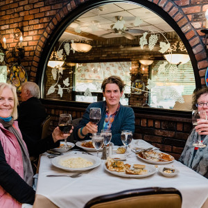 table of people enjoying drinks and food