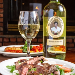 wine bottle and glass and steak dish and chicken dish